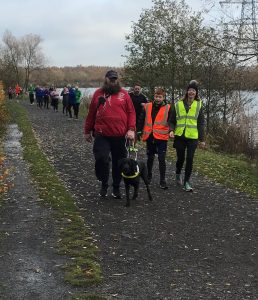 Image shows a Goalball UK parkrun participant with their guide dog