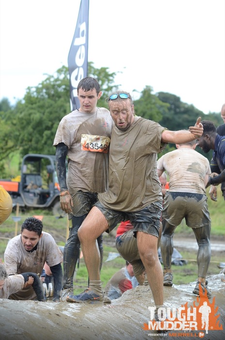 Action shot of our participants going through the Mud Mile obstacle