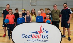 An image featuring lots of smiley faces and the Junior end of season tournament. This also features GB Men's Head Coach Faye Dale and star player Dan Roper.