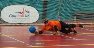 Sally Britton getting her finger tips to a goalball.