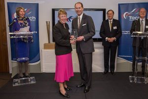 Dina Murdie receiving an award from the Torch Trophy Trust.