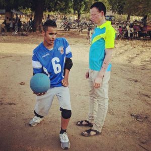 Sal Gamil from Birmingham Goalball Club demonstrating a goalball throwing technique to a participant in Ghana.