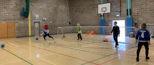 Cambridge Dons returning to training in October 2020. Image shows players distanced throwing goalballs.