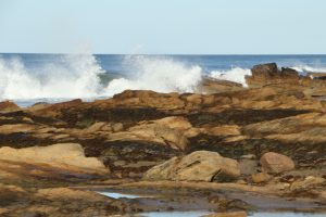 Waves crashing against Hopeman East Beach on a sunny day!