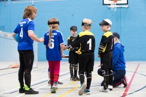 Warren Wilson coaching a group of junior players during a goalball session.