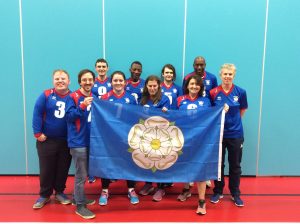 Images shows Ben with his South Yorkshire team. All are stood smiling holding a Yorkshire flag.