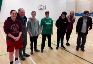 Reanne Racktoo stood in a group photo at a blackburn Goalball club training session wearing a Manchester United top.