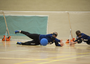 Image of a Goalball player saving in front of goal