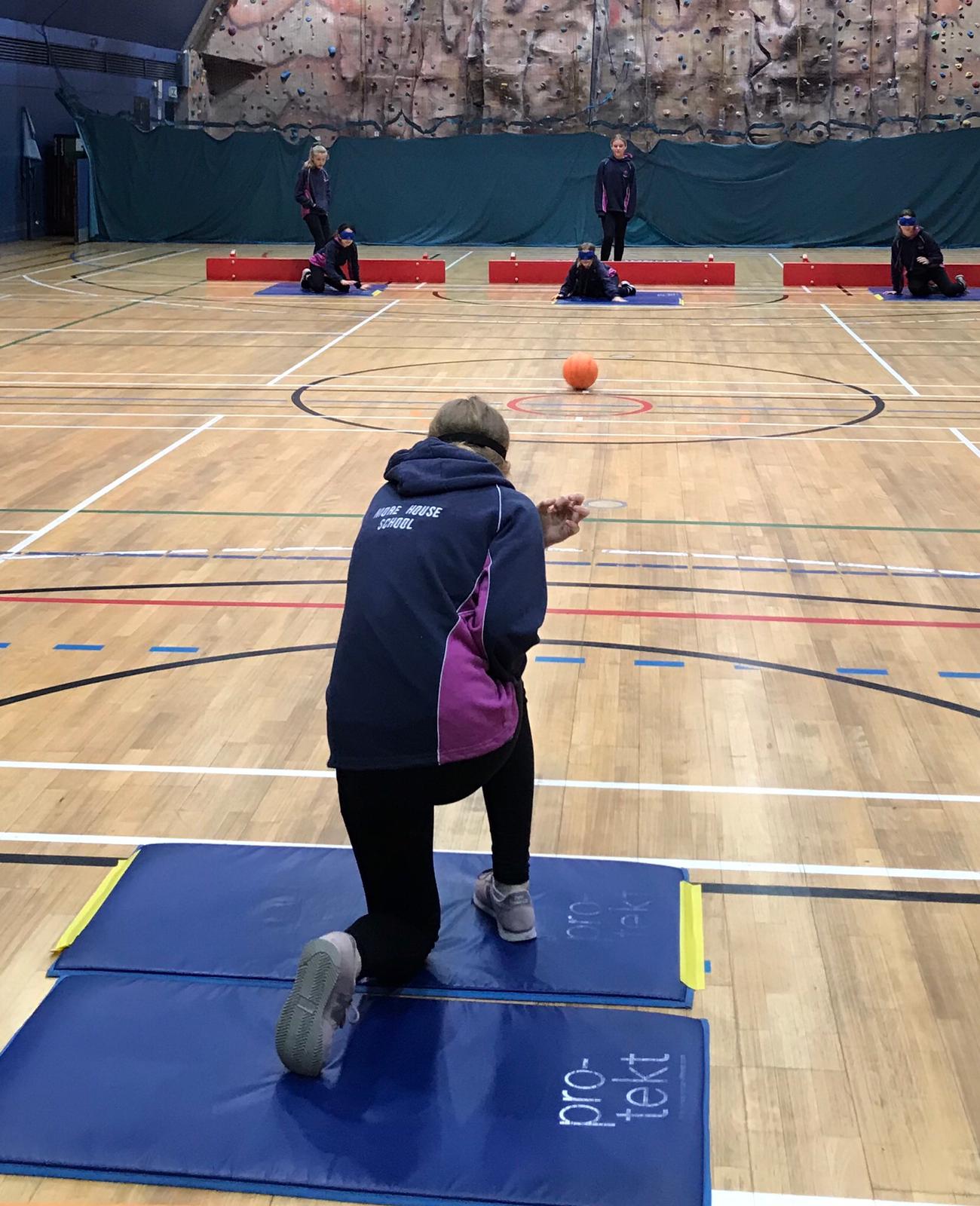 Action shot from Goalball UK School session in London, taken from behind the players