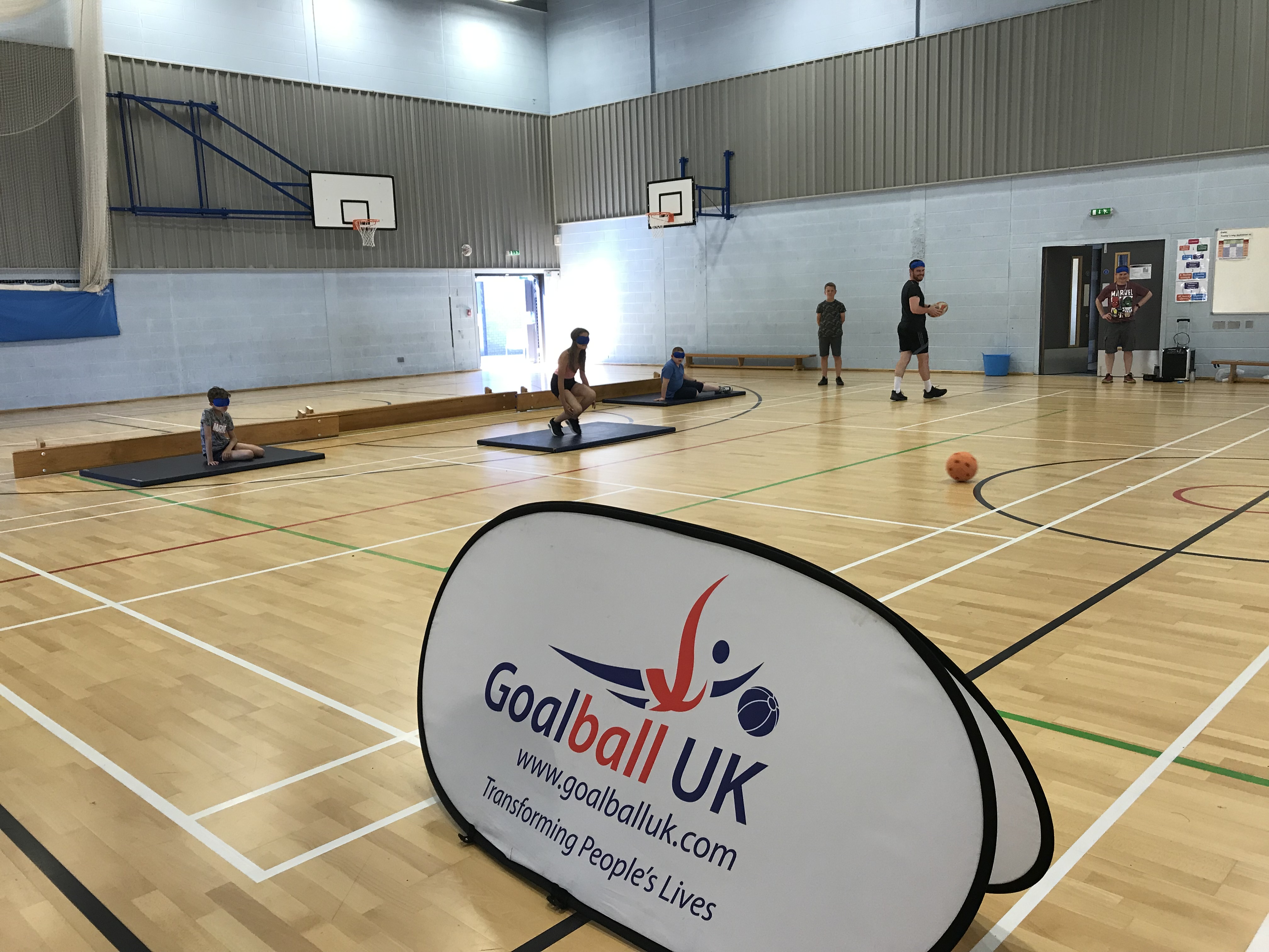 Action shot taken at school transition event, with Goalball UK banner in goreground
