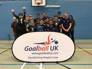Group photo at Norwich Goalball Club with players and coaches, and Goalball UK staff Tom and Steve