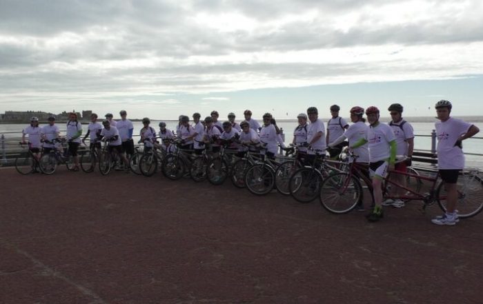 Coast to Coast participant group photo at the start line in Morcambe.