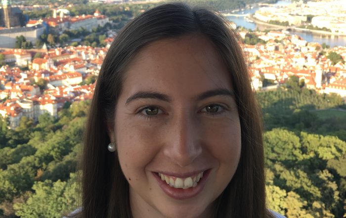 Ashleigh smiling, with Prague in the background
