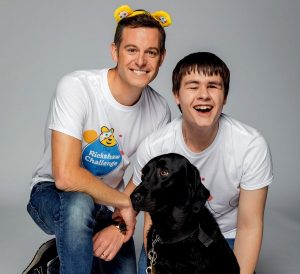 Goalballer Kelsey, smiling, with BBC presenter Matt Baker. Used in promotion of the 2019 Children in Need Rickshaw Challenge