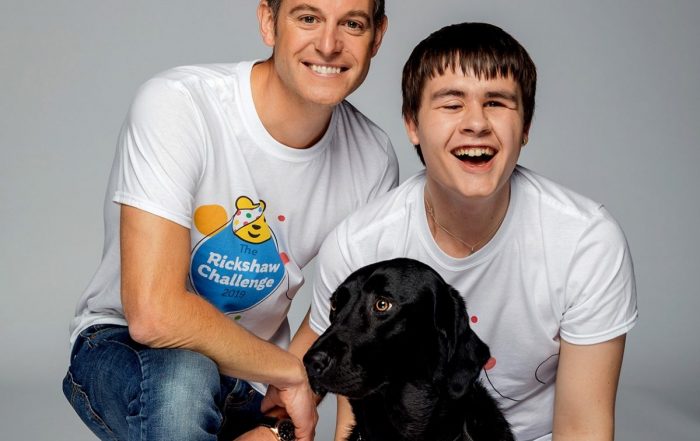 Goalballer Kelsey, smiling, with BBC presenter Matt Baker. Used in promotion of the 2019 Children in Need Rickshaw Challenge