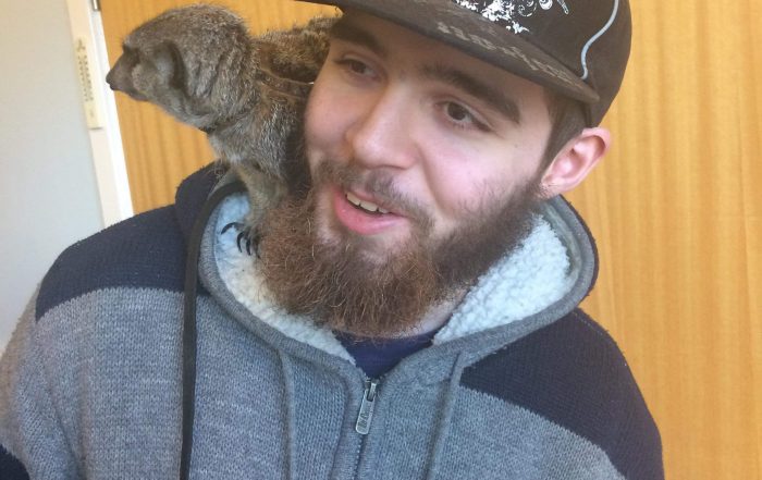 Picture of Danny, with a meerkat on his shoulder.