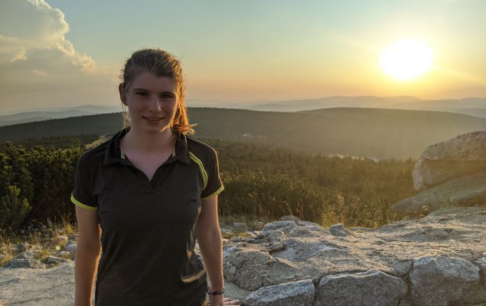 Magda with a mountainous landscape in the background
