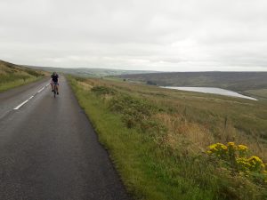 Phil cycling on a quiet road up in the Pennines