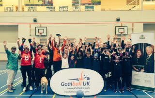 London Cup 2019 group photo with everyone's hands in the air smiling in elation!