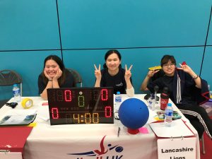 Sheffield North region tournament. This image features table officials posing with smiley faces before a goalball game.