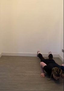 Image shows Megan on the floor in a pressup position