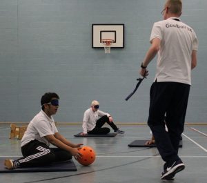 Stephen Newey, Goalball UK's Children & Young People's Officer coaching goalball to school pupils.