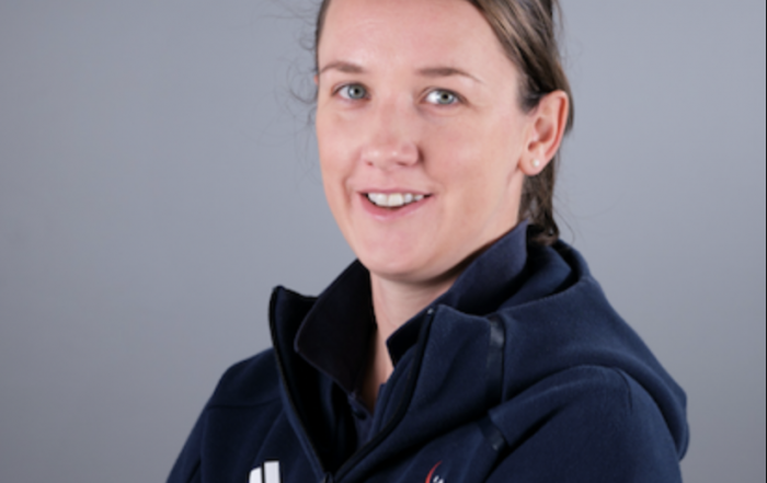 Image shows Faye stood smiling at the camera in her GB jacket with her arms crossed