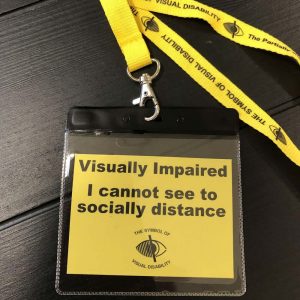 A lanyard that says "Visually Impaired - I cannot see to socially distance.