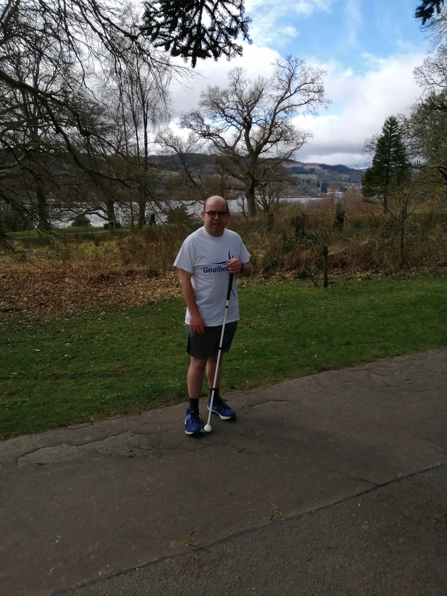 Graeme stood in the park wearing a Goalball UK t-shirt