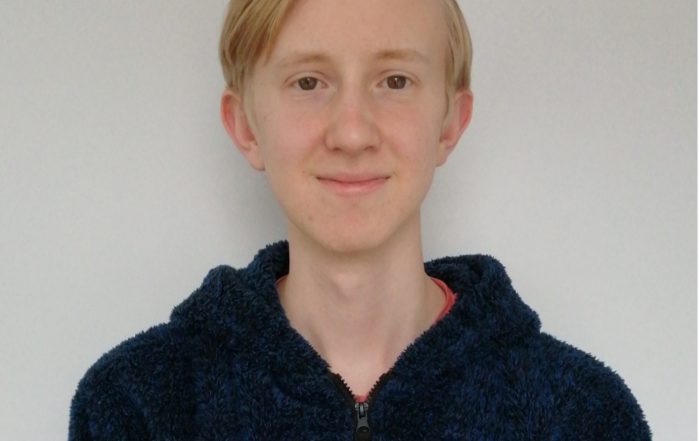 Image is a headshot of Leo Johnson smiling at the camera
