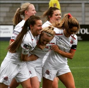 Jodie Redgrave, pictured in the middle of the image amongst her team mates at Fylde FC celebrating a goal!