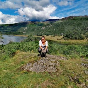 Josie Hewson stood on top of a mountain she climbed with her furry four legged companion.