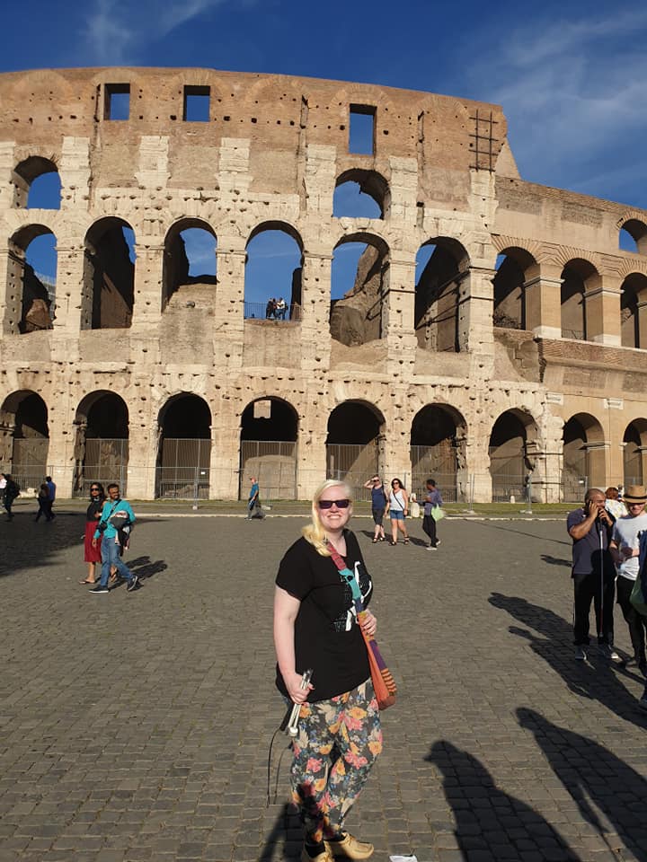 Sammie Korosi in front of the Colosseum in Rome, Italy on a very sunny day!