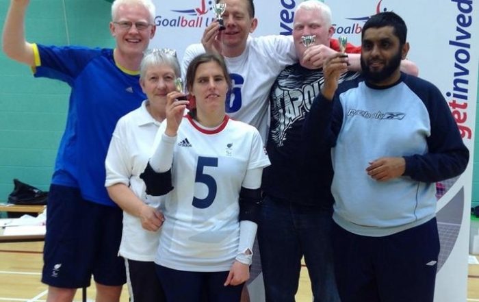 Mohammed Javid stood in a group who are all holding small trophies after the marathon tournament!