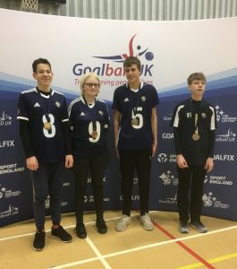 Arthur Milles stood in a group photo at a Goalball UK tournament.