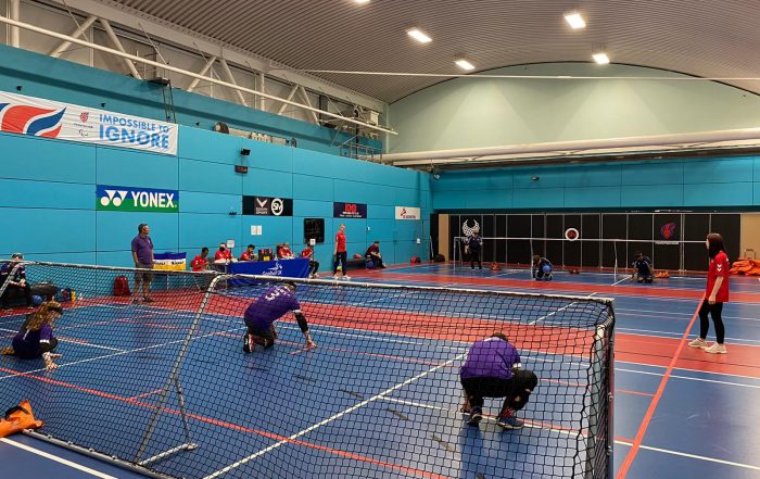 Picture taken behind the goal of Scarborough Panthers in purple jerseys against Mersey Sharks on the other side of the court.