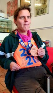 Louise wearing her London Marathon t-shirt and medal.