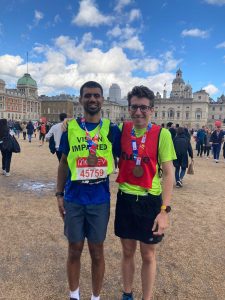 Naqi stood with his guide runner after the race. They are both wearing their medals.