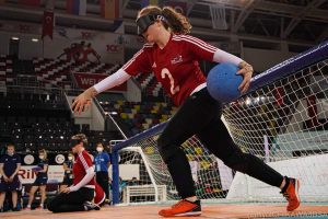 Antonia Bunyan shooting a goalball whilst wearing a red GB top.