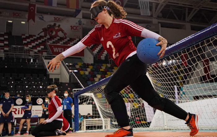 Antonia Bunyan shooting a goalball whilst wearing a red GB top.