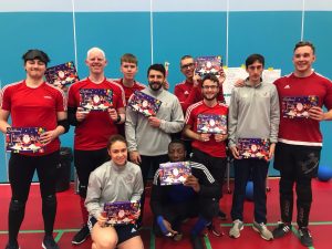 GB Men's squad all stood together after a training camp with chocolate selection boxes.