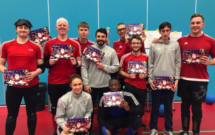 GB Men's squad all stood together after a training camp with chocolate selection boxes.