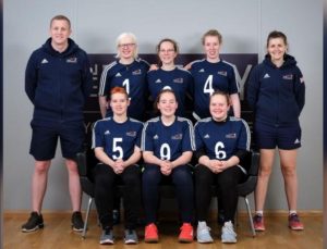 GB Women's team group photo with three players sat together at the front and three players stood behind them. Two coaches are stood either side.