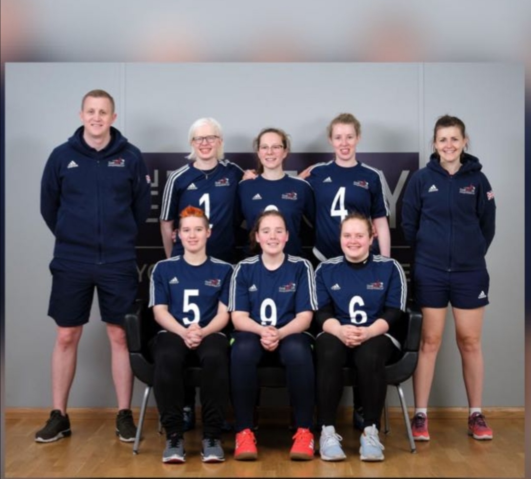 GB Women's team group photo with three players sat together at the front and three players stood behind them. Two coaches are stood either side.
