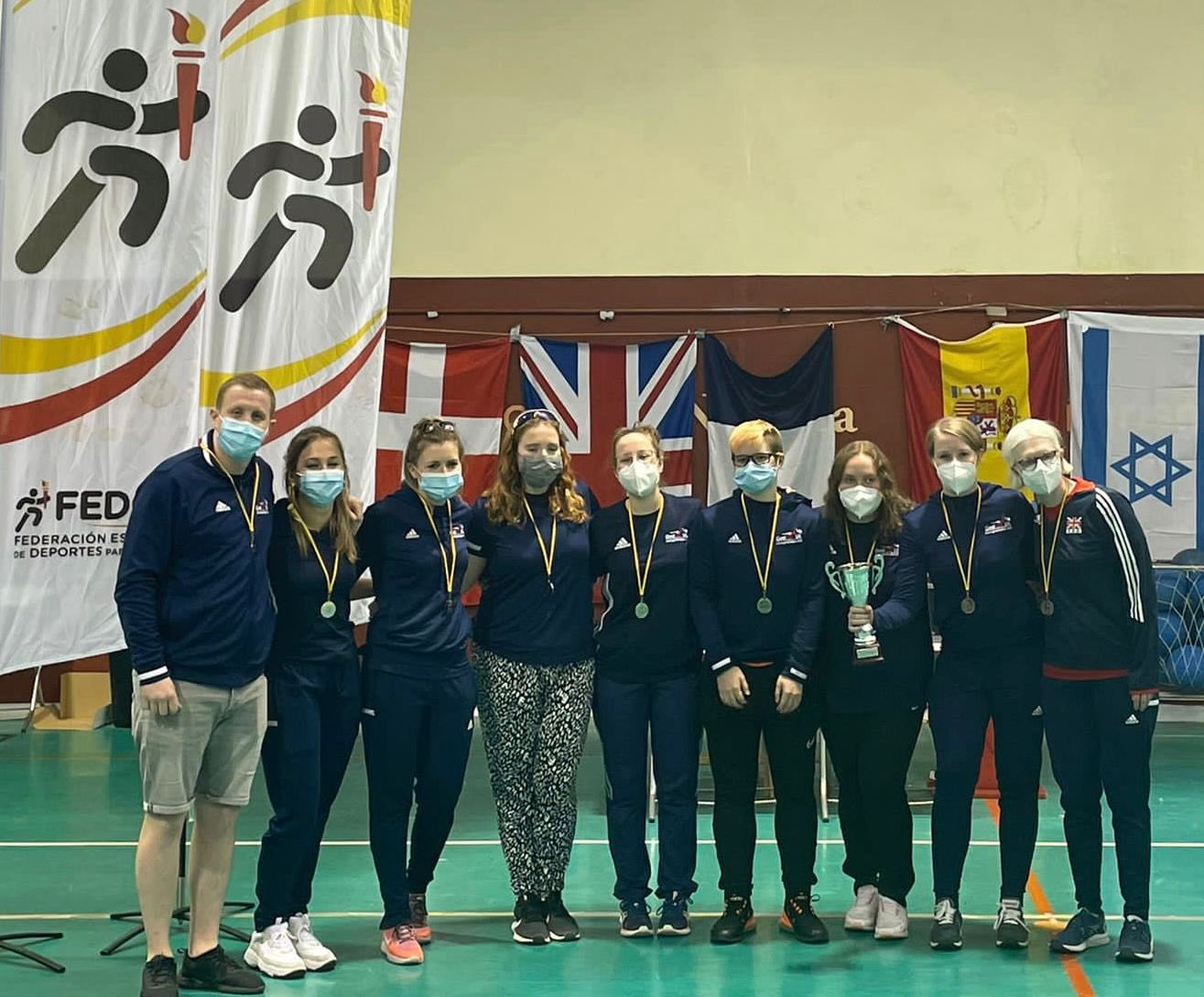 GB Women's team stood together in a line after receiving their silver medal at a tournament in Madrid.