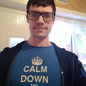 Matt Wooff taking a selfie, Matt is wearing a blue shirt and a jacket.