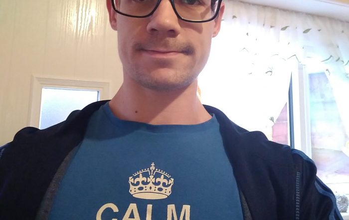 Matt Wooff taking a selfie, Matt is wearing a blue shirt and a jacket.
