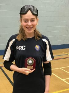 Phoebe stood with a small trophy whilst wearing her navy blue Winchester training top and black eyeshades.