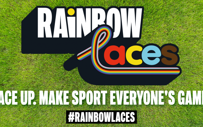 Rainbow Laces graphic. The wording rainbow laces is in front of a grass background with the tagline "Lace up. Make sport everyone's game" underneath