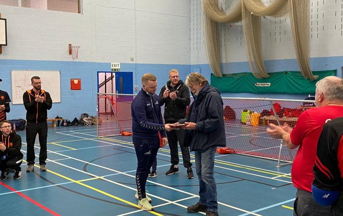 Dave Potter receiving the Service to Sport award from Tom Dobson at the Intermediate North Matchday in York (27.11.21)